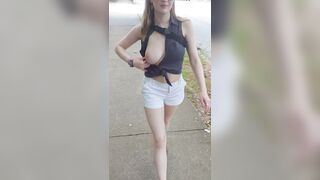 Letting her tits breathe while walking out in the streets